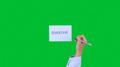 Arzt-Schreibt-Remdesivir-Auf-Papier-Mit-Grünem-Bildschirm
